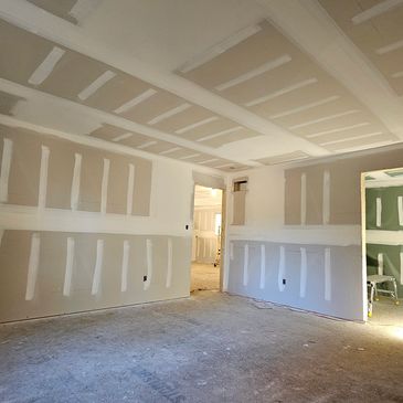 Interior view of a mud and tapped room under construction.