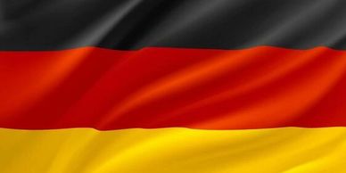 Waving flag of Germany with black, red, and gold stripes.