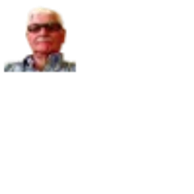 Elderly man wearing glasses and a checkered shirt.