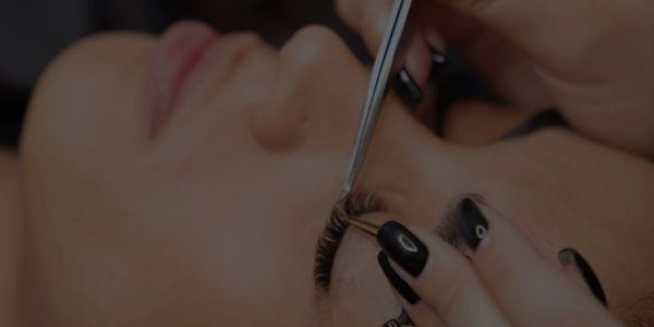 Applying eyelash extensions on closed eyes.
