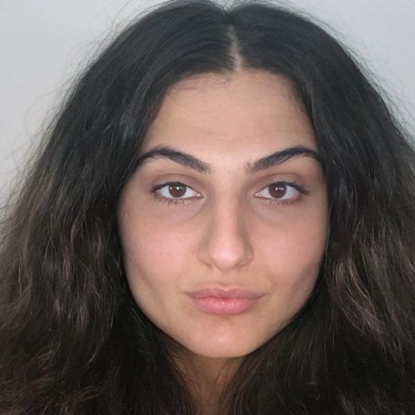 Portrait of a woman with long dark hair and natural makeup.