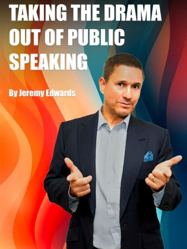 Man in suit pointing with both hands against colorful background.