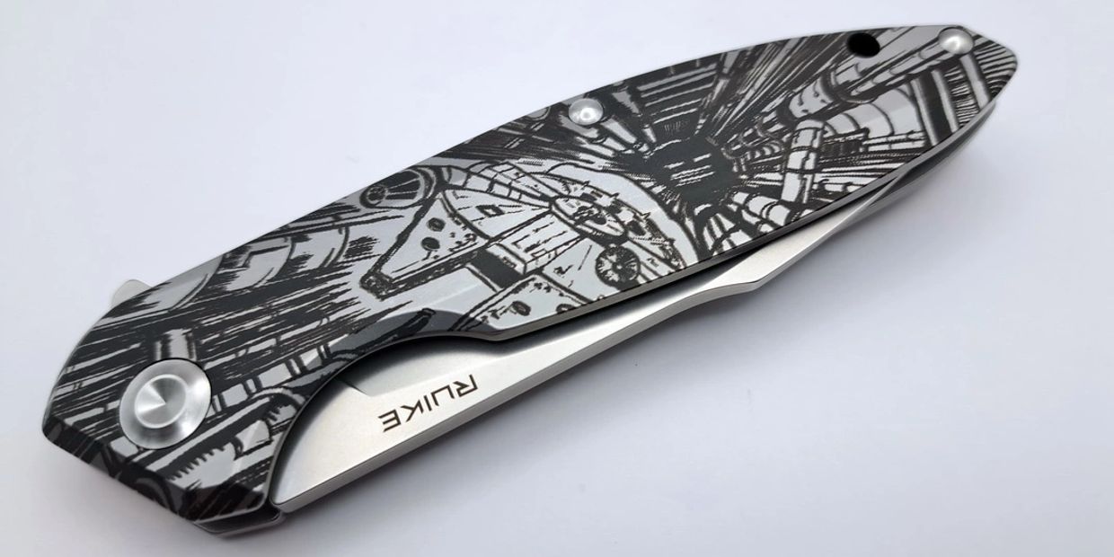 Close-up of a folding knife with detailed Star Wars design.