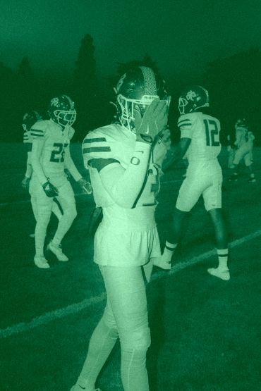 Football players preparing on the field.