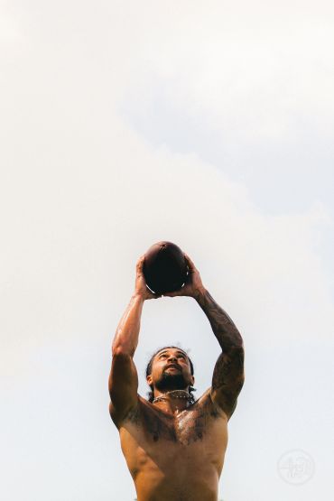Man catching a ball in the air.