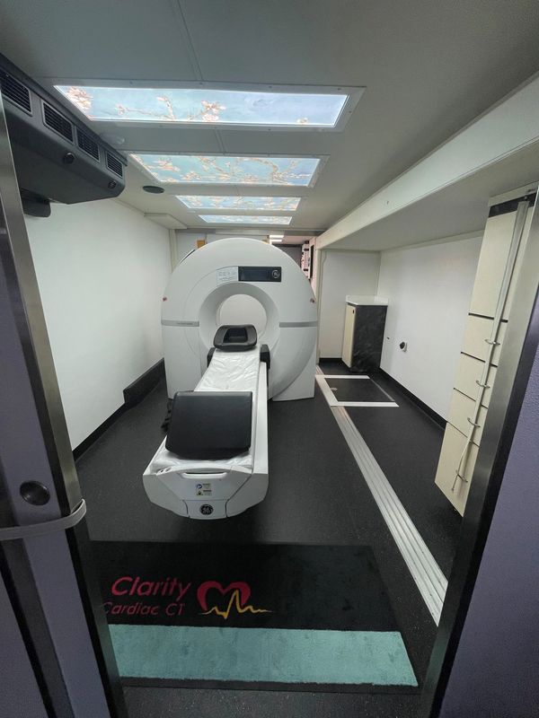 A modern Clarity Cardiac CT scanner in a clean, well-lit room.