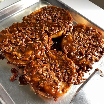 Sticky pecan sticky buns on a metal tray.