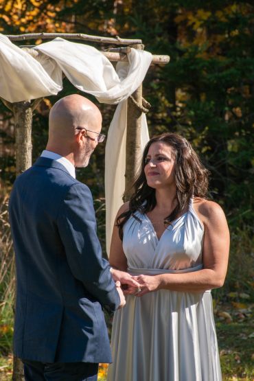 Couple exchanging vows during an outdoor wedding ceremony.