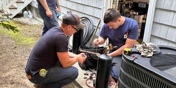 Air Conditioning Install in Progress Employees Learning and Working Together