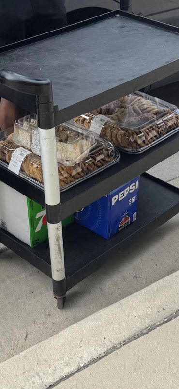 Cart with cookies and soda boxes.