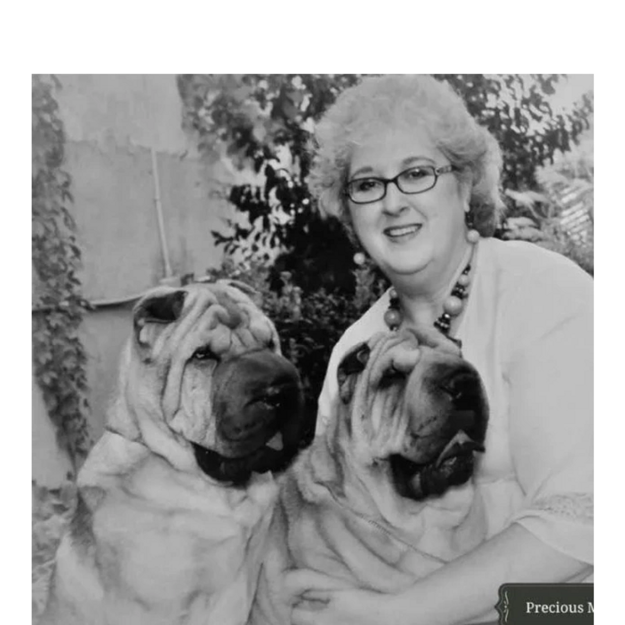 a woman posing with two dogs 
