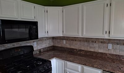 This is the finished kitchen with new paint for the cabinets as well as a vibrant color for the wall