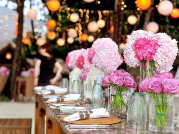 Elegant table setting with pink floral arrangements.