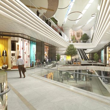 Spacious modern shopping mall interior with shops and escalators.