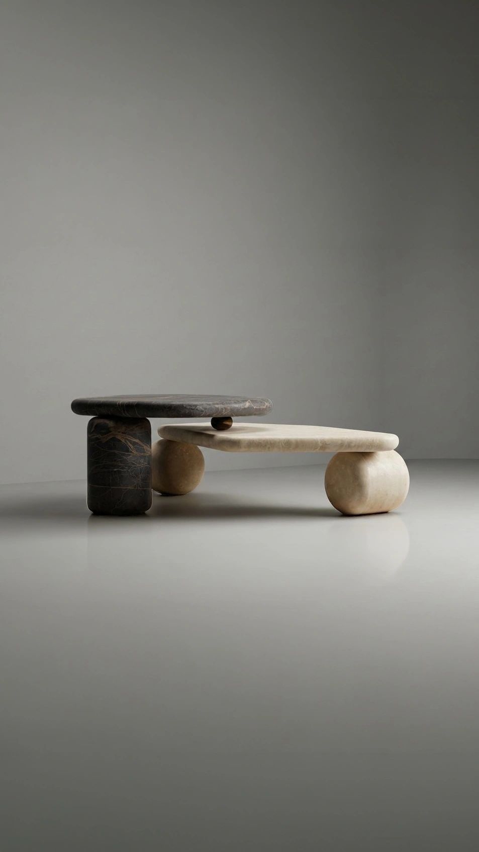 Minimalist dual-level stone table with contrasting dark and light tones.