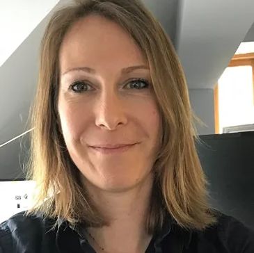 Smiling woman with shoulder-length hair.