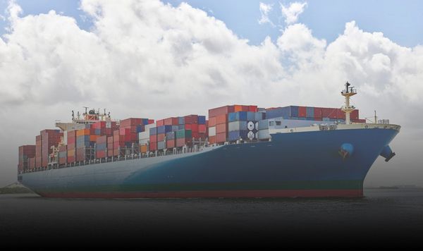 ship on water with blue sky and clouds