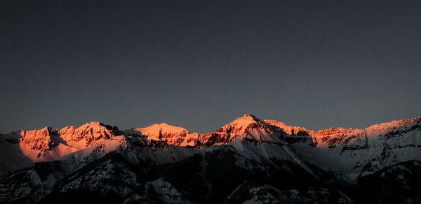 grey sky with mountains with pink peaks