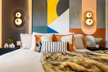 Hand painted murals to make the bedroom pop in your Airbnb