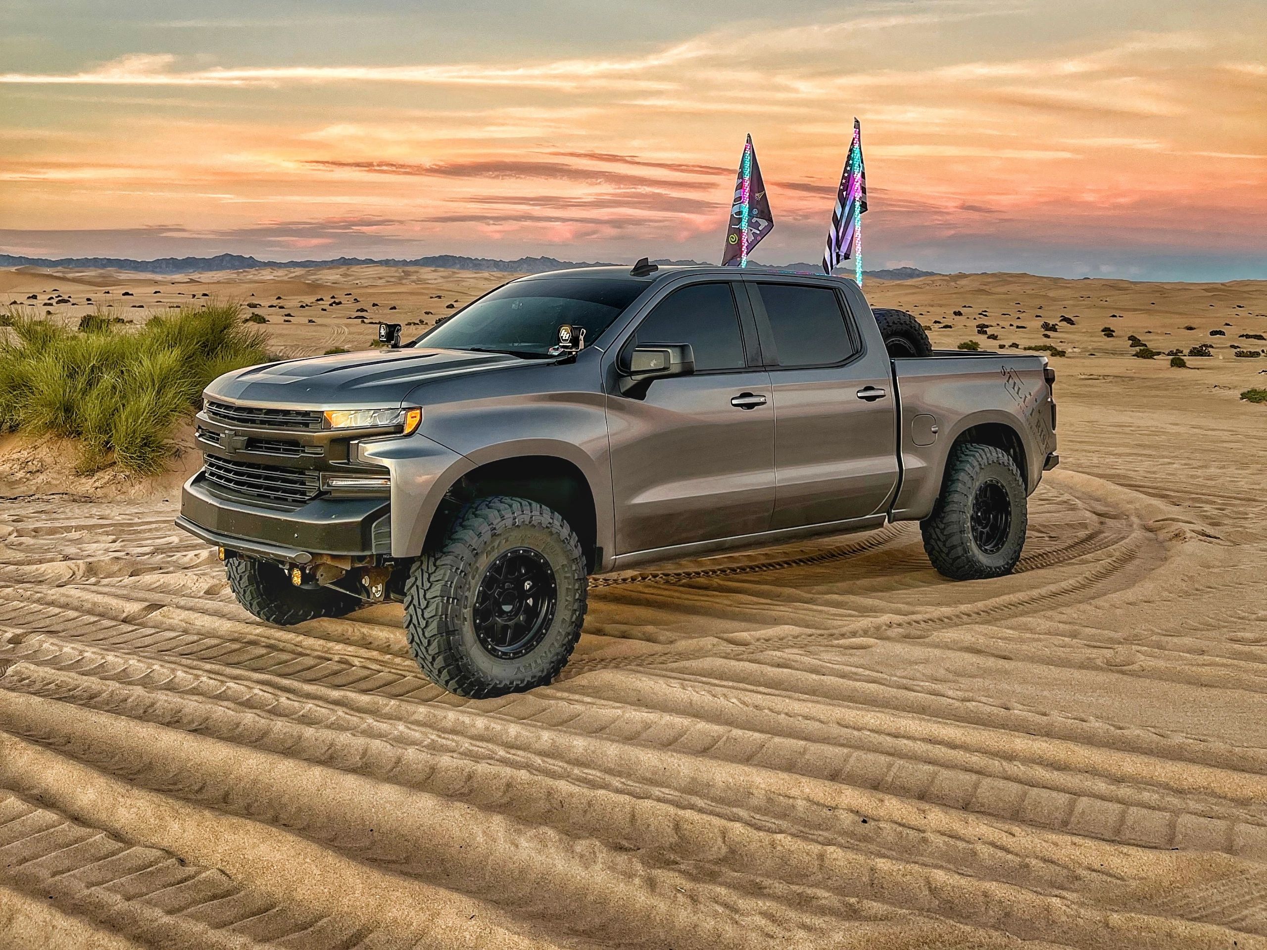 PHOTOS OF A CHEVY TRUCK , CAN AM  AND RZR 800 PARKED IN THE IMPERIAL SAND DUNES