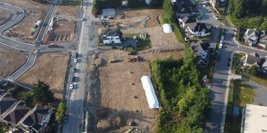 Aerial view of a residential construction site with homes and roads.
