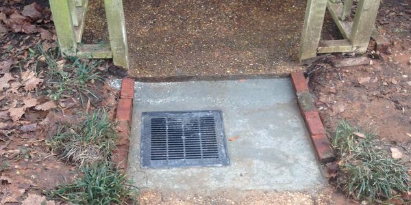 ponding mitigation using landscaping techniques in front of a residential door. 