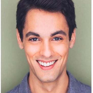 Young man smiling confidently at the camera.