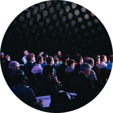 Audience listening attentively at a conference or presentation.