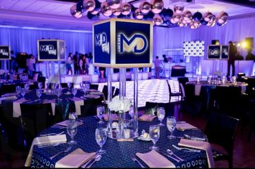 Elegant event setup with modern lighting and decorated tables.