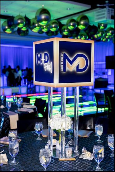 Illuminated MD Fun centerpiece at an elegant event table.