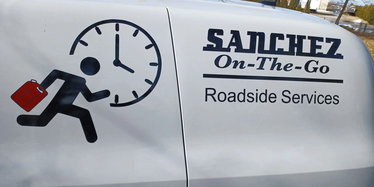 Van side with logo for Sanchez On-The-Go Roadside Services, showing running figure with gas can and clock.