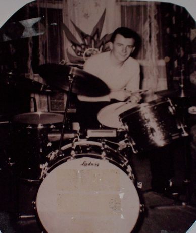 Vintage photo of a man playing drums.