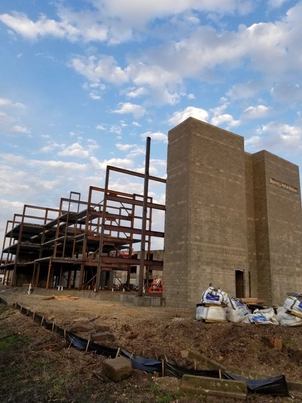 Construction site with steel framework and concrete structure.