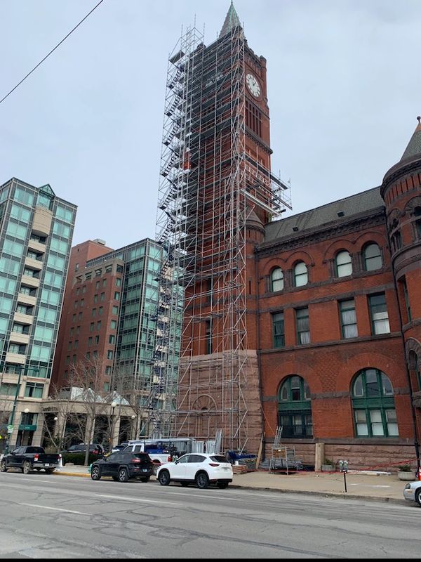Clock tower under renovation with scaffolding.