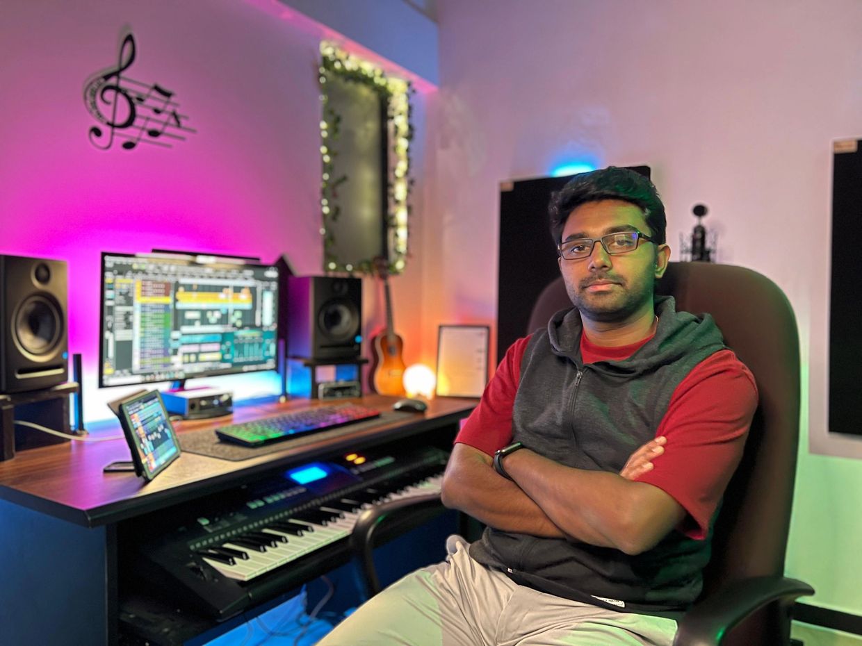 Man sitting in a colorful music studio.