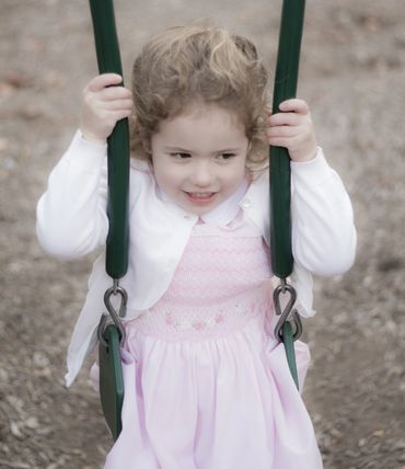 child on a swing. Aspyre Productions portraits