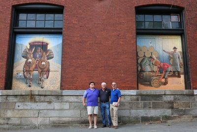 Logan McCracken, Dick Yuengling Jr., and Mark Sassani with Eagle Brewery murals, Pottsville, PA