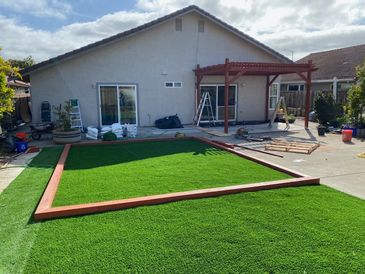 Turf being installed on a backyard
