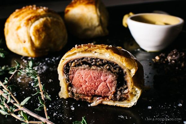 Beef Wellington cut to show medium-rare center.