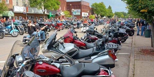 Picture of downtown Tomahawk Wisconsin lined with motorcycles.