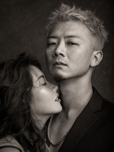 Black and white portrait of a couple embracing, showing strong emotions.