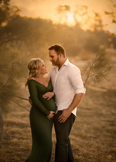Couple sharing a tender moment during a golden hour outdoor photoshoot.