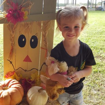 A little girl wearing a black shirt showing her face