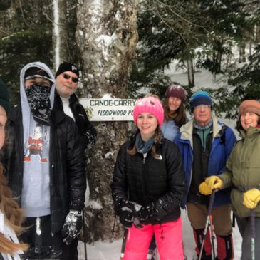Group of people snowshoeing on portage from Floodwood Outpost and Long Pond