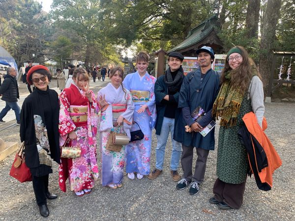 Group of people posing outdoors, some in traditional Japanese kimonos.