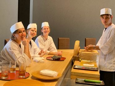 Group of young chefs in a culinary classroom or kitchen.