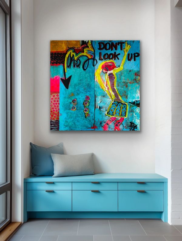 Colorful modern art above a blue bench with cushions.