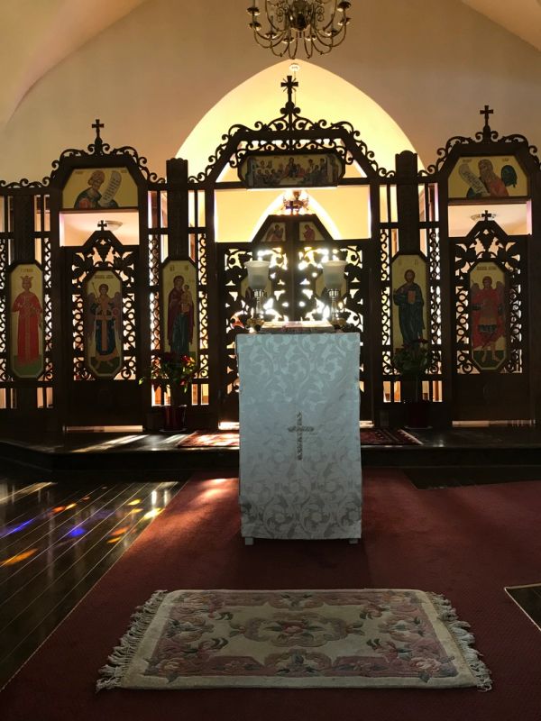 Ornate church altar with icons and candles.