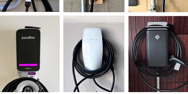 Three electric vehicle charging stations with neatly coiled cables mounted on walls.