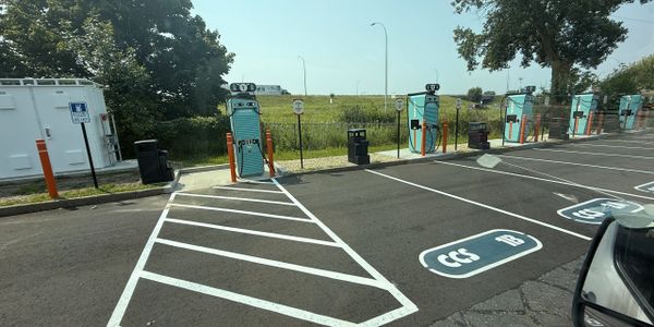 Empty electric vehicle charging stations on a sunny day.